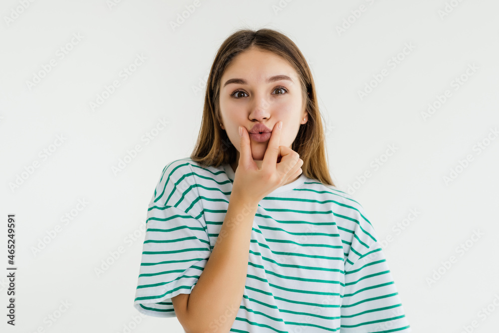 Young woman touches her face around her mouth on white background Young woman touches her face around her mouth on white background