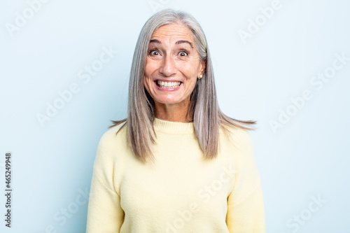 middle age gray hair woman looking happy and goofy with a broad, fun, loony smile and eyes wide open