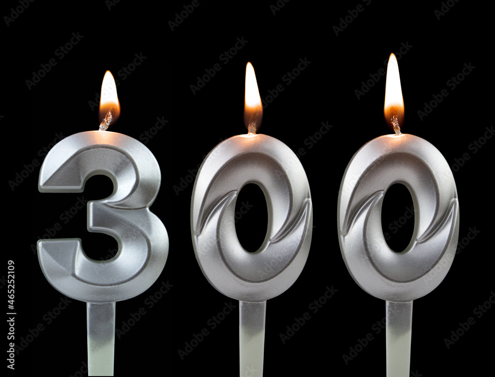 Silver birthday candles isolated on black background, number 300 Silver birthday candles isolated on black background, number 300