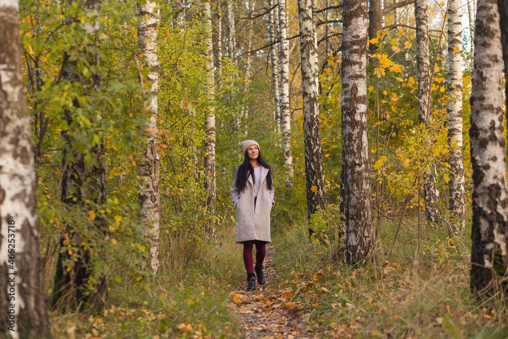 Portrait of a joyful young woman enjoying in the autumn park. Portrait of a joyful young woman enjoying in the autumn park.