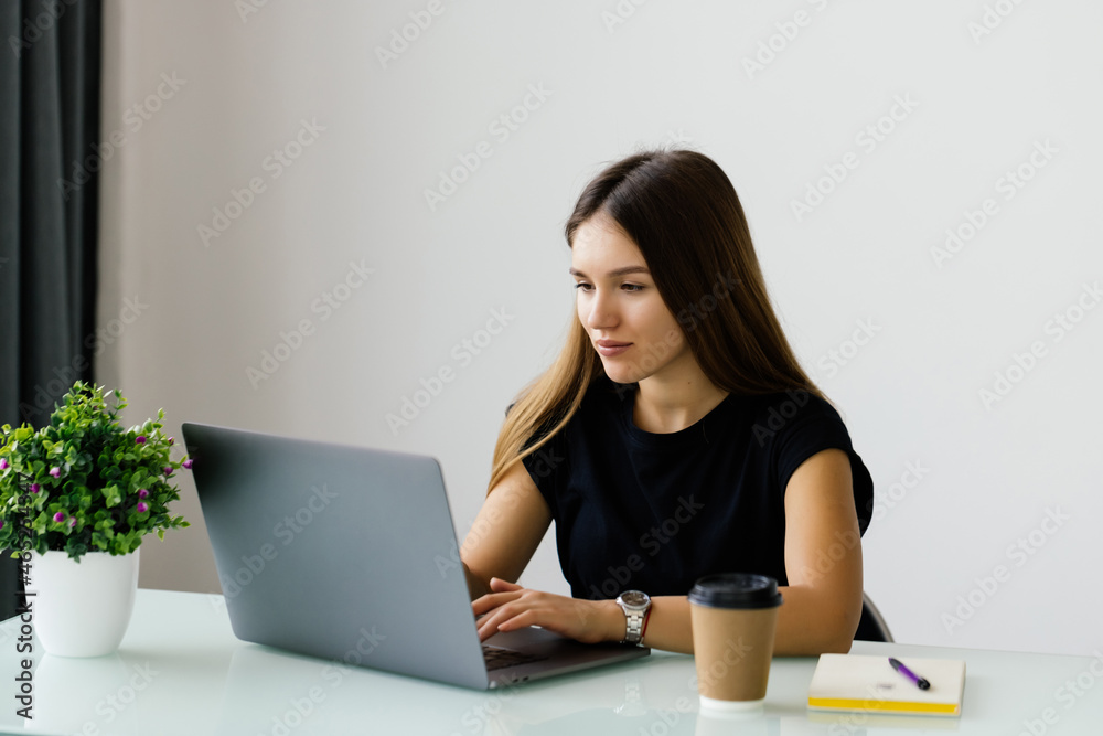 Portrait of young business woman using laptop at office Portrait of young business woman using laptop at office