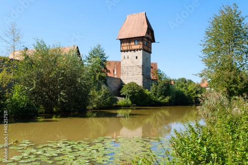 Germany, Bavaria, Dinkelsbuhl, Wornitz River in summer with Bauerlin Tower in background photo