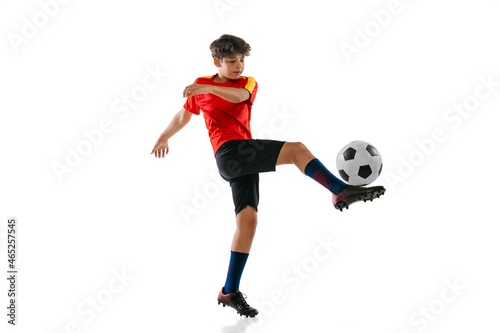 Obraz na plátně Full-length portrait of boy, male soccer football player training isolated on white background