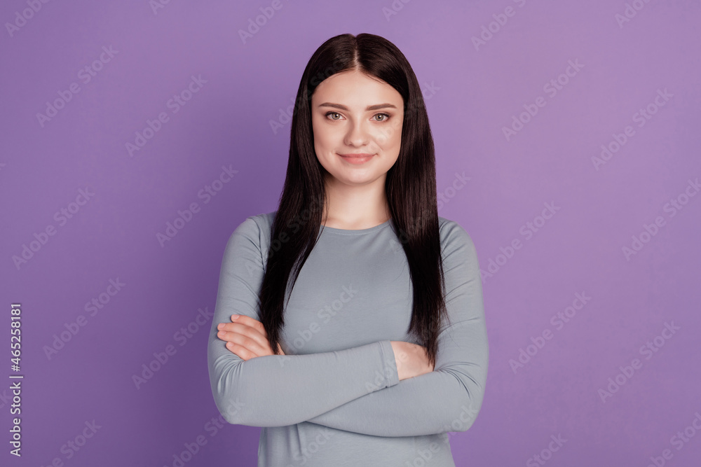 Photo of young pretty girl good mood crossed hands clever agent isolated over violet color background Photo of young pretty girl good mood crossed hands clever agent isolated over violet color background
