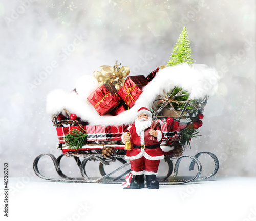 Merry Christmas and Happy Holidays! Santa Claus gives gifts. photo