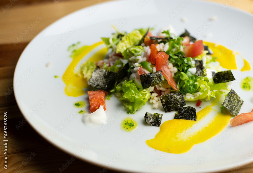 Delicious rice salad with lettuce, tomato, escarole and seaweed. Gourmet salad with natural products. Delicious rice salad with lettuce, tomato, escarole and seaweed. Gourmet salad with natural products.