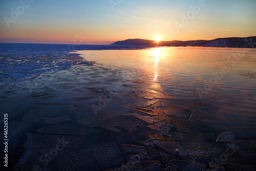 Sunset on Lake Baikal. Melting ice and open water in the lake. 