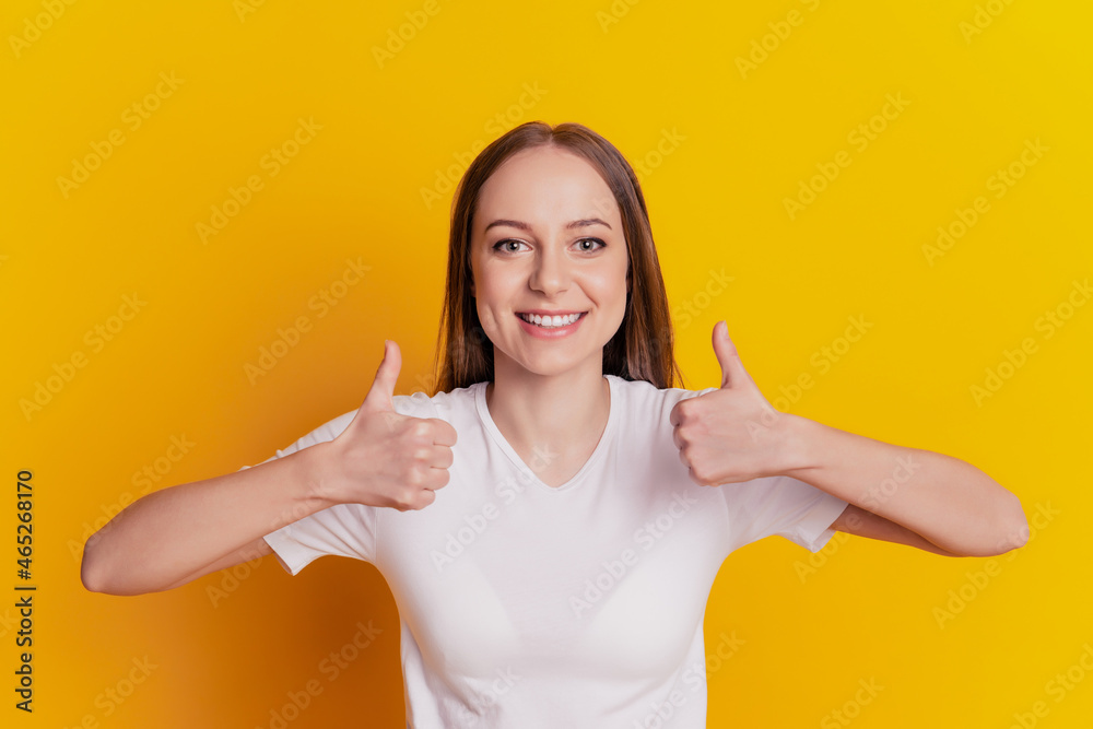 Photo of young girl good mood show thumb-up like cool advertise recommendation isolated over yellow background