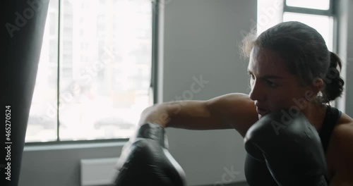 Wallpaper Mural Woman kickboxer in boxing gloves punches boxer bag in slow motion, training in boxing club, 4k 60p Prores HQ Torontodigital.ca