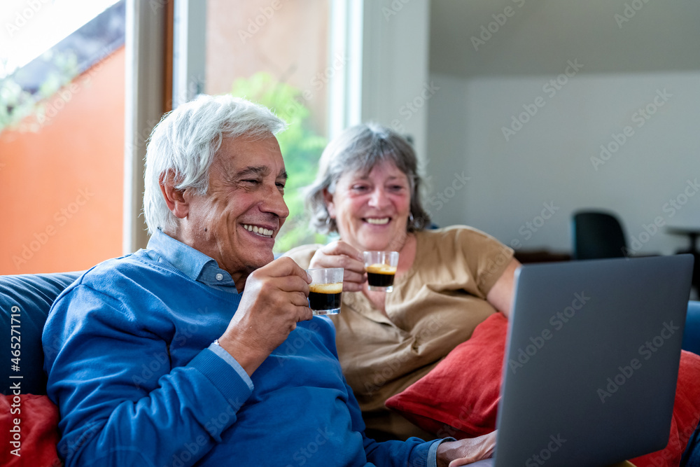 Happy old senior couple with laptop computer having video call, retirement senior couple lifestyle old age using connecting technology, quarantine concept