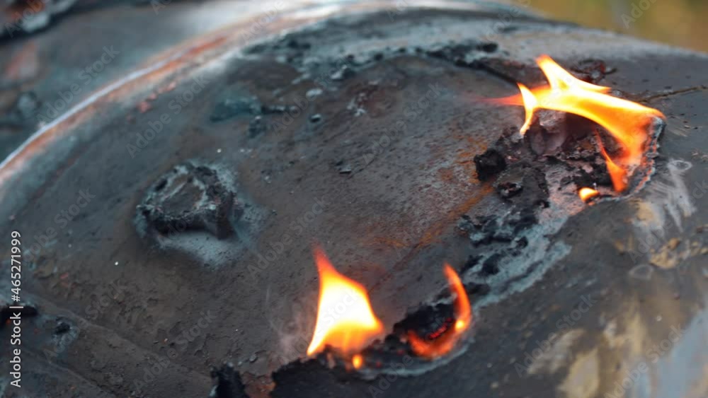 The skin on the metal of the damaged vehicle is burning. Open fire close-up with wiring. The concept of tragedy or crash. Detail of charred wreckage. 4k video The skin on the metal of the damaged vehicle is burning. Open fire close-up with wiring. The concept of tragedy or crash. Detail of charred wreckage. 4k video