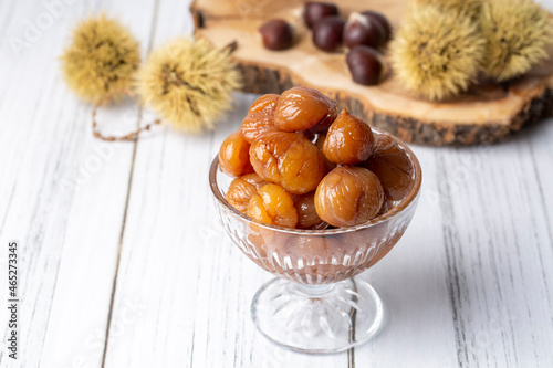 Chestnut dessert and chestnuts on a plate. Traditional delicious Turkish dessert; chestnut candies (Kestane Sekeri) photo