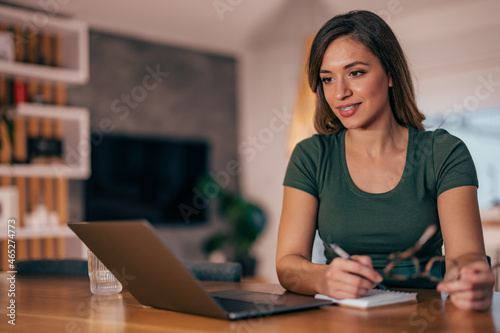 Young woman, making sure she has positive credit score. photo