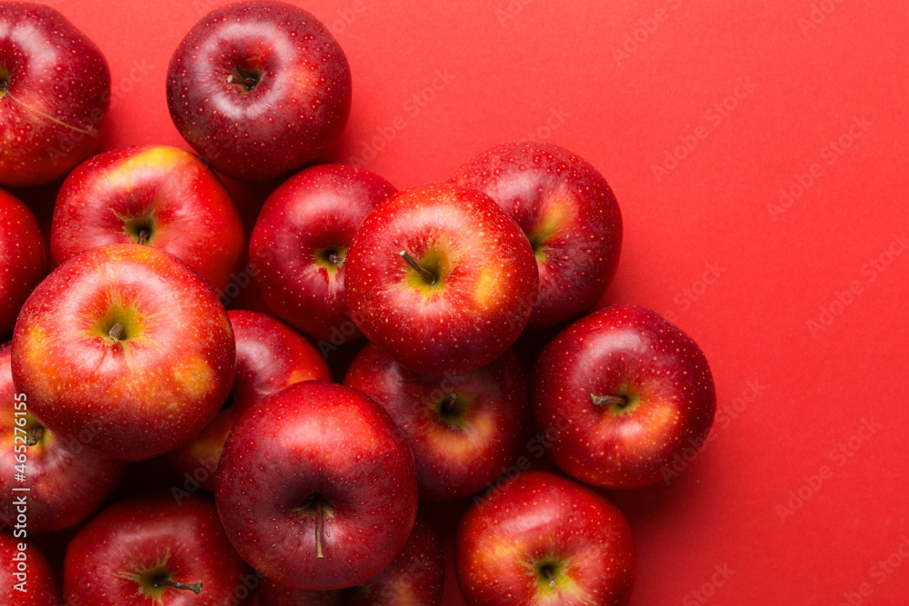 Many red apples on colored background, top view. Autumn pattern with fresh apple above view with copy space for design or text Many red apples on colored background, top view. Autumn pattern with fresh apple above view with copy space for design or text