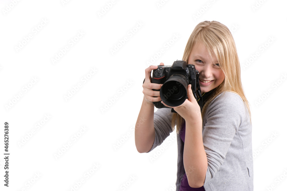 Young happy teenage girl holding a digital camera and prepare to take a photo. Isolated on white. Young happy teenage girl holding a digital camera and prepare to take a photo. Isolated on white.