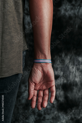person wears a transgender pride wristband © nito