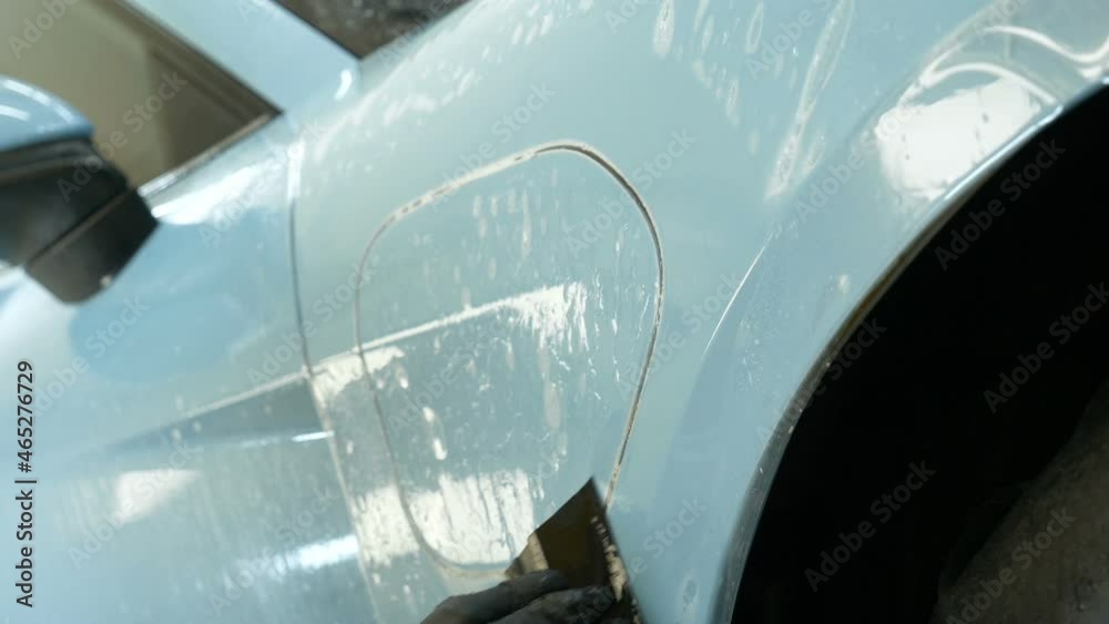 Close up to PPF installation process on a front headlight and hood. PPF