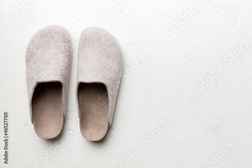 Warm winter women woolen slippers on colored background. Copy space for text photo
