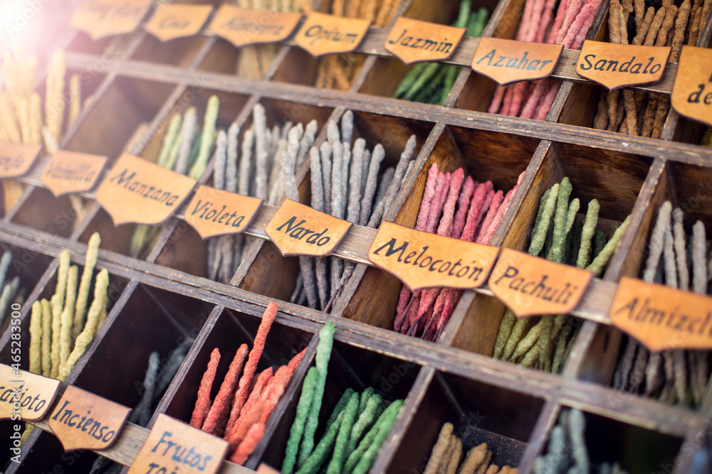 Colorful incense sticks in outdoor street shop with names in spanish