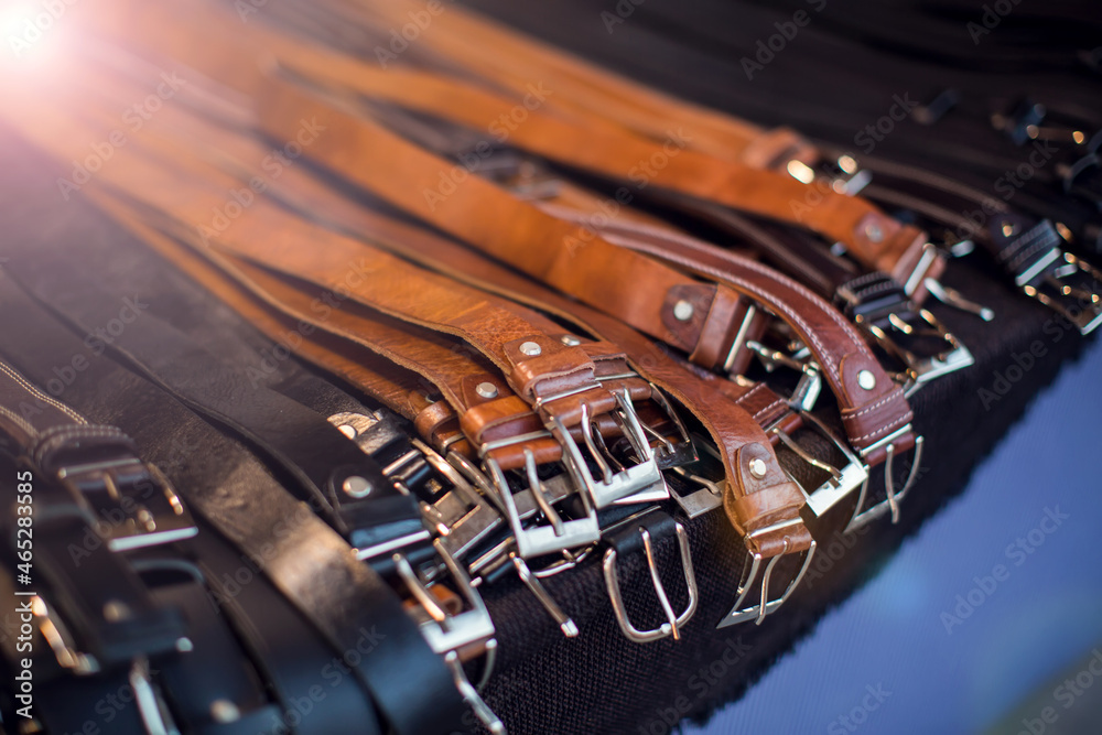 Obraz premium Men's belt of different colors in the shop