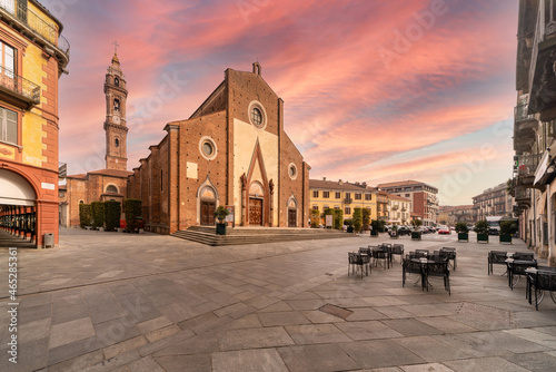 Saluzzo, Cuneo, Italy - October 19, 2021: Maria Vergine Assunta cathedral (16th century) in Piazza Giuseppe Garibaldi with sky and colorful clouds at sunset photo