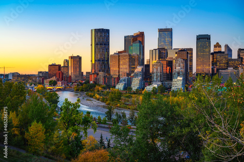Sunset above city skyline of Calgary with Bow River, Canada photo