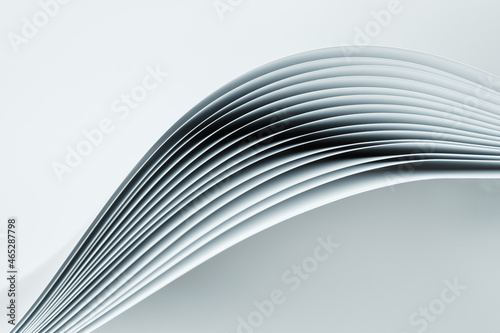 Several curved sheets of paper on a white background