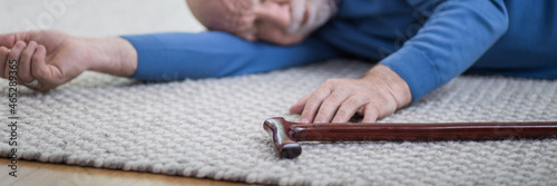 Billede på lærred Senior man in blue sweater lying on the floor of his apartment