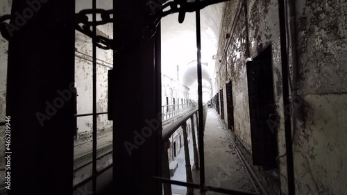 Camera view of cellblock pedestals up and down through gate at Eastern State Penitentiary.