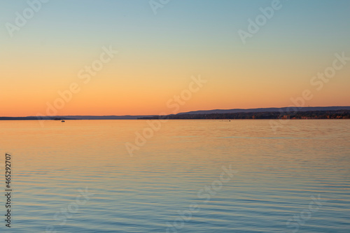 Beautiful sunset reflecting on gently rippled water © Karen Hogan