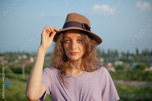 Young girl in dress is having great time during vacation in the summer on sky background in nature, travelling concept © Ольга 