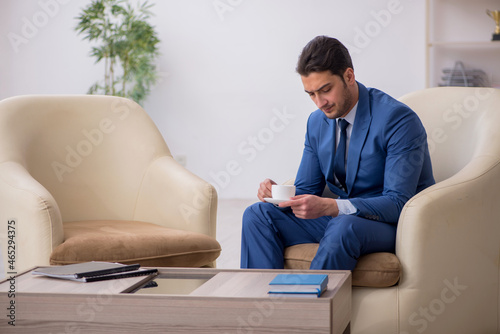 Young male employee waiting for business meeting