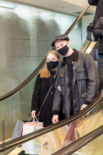 Black friday pandemic concept. Young couple in black masks at the mall