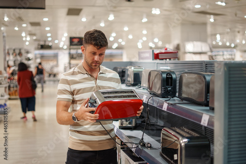 Fotografía Man selecting toaster in mall