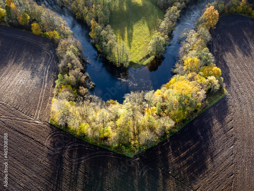 Aerial view of river, agriculture fields and trees. Drone photography taken in Sweden in autumn, October.
 photo