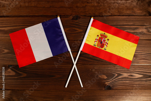 Flag of France and flag of Spain crossed with each other. The image illustrates the relationship between countries. Photography for video news on TV and articles on the Internet and media.