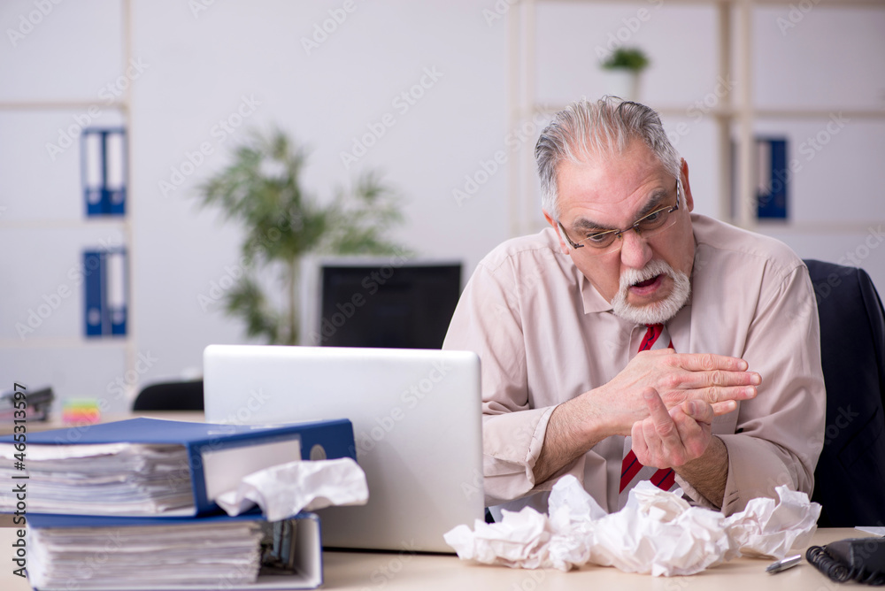 Old male employee in brainstorming concept