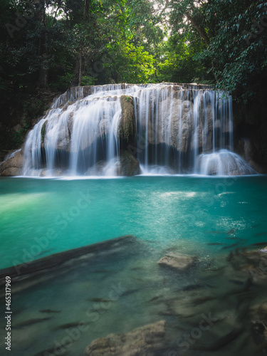 Scenic view of famous Erawan Waterfall. Breathtaking smooth flowing water stream with turquoise lagoon and fish in lush rainforest. Kanchanaburi  Thailand. Long exposure.