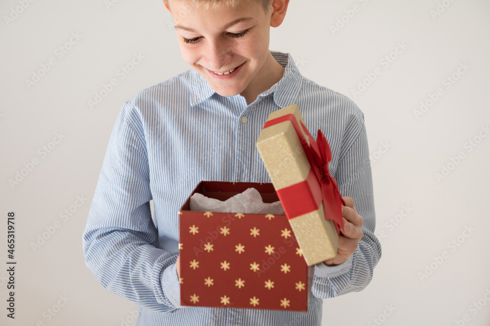 Happy and surprised teenage boy open beautiful present box Happy and surprised teenage boy open beautiful present box