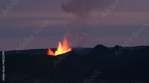 Volcanic eruption at dusk. Lava splash. Smoke