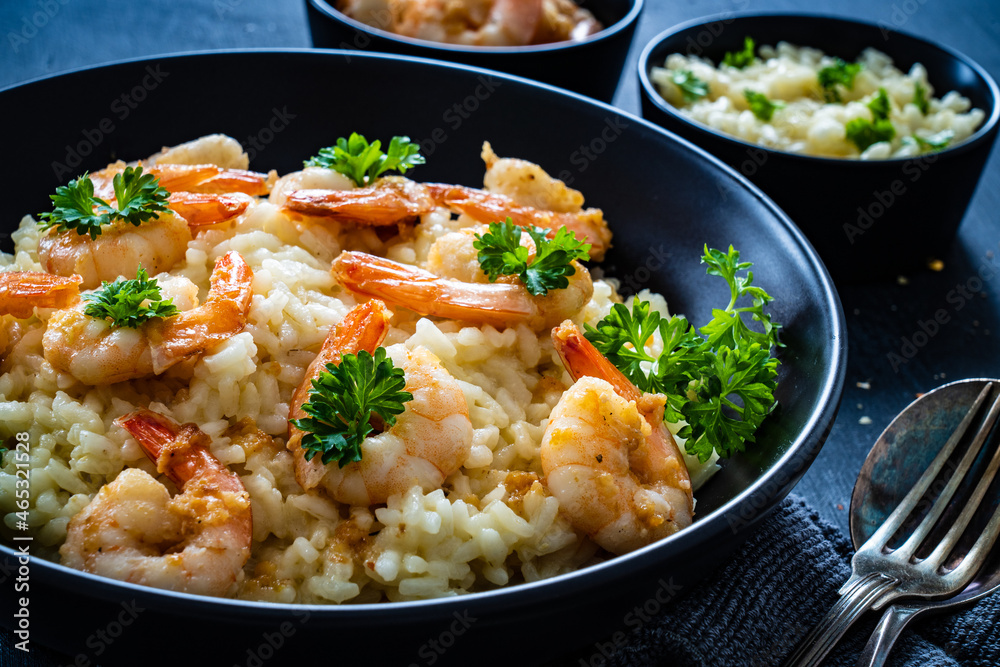 Risotto with prawns, chili and parsley on wooden table
Risotto with prawns, chili and parsley on wooden table