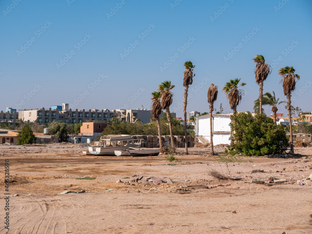 Old boats on the sandy shore against the sky and palms. Old boats on the sandy shore against the sky and palms.