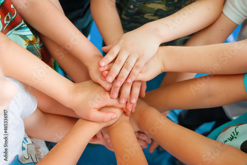 Team building. Children's hands. Group activity for children. The concept of achieving a common goal in a team.
