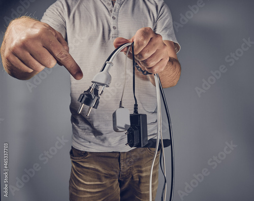 Man with many electricity plugs
