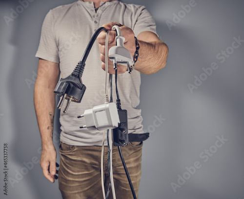 Man with many electricity plugs