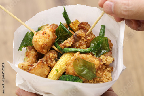 Taiwanese popcorn chicken with fried basil, and you can usually choose other ingredients to get deep fried, and mixed together, like garlic, basil, broccoli, green beans etc. photo