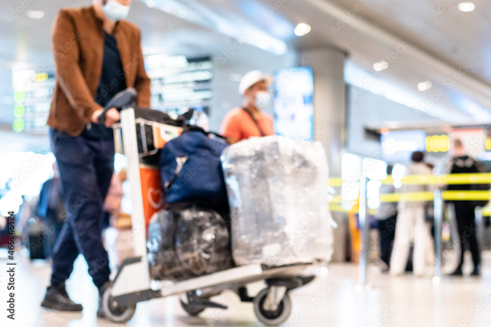blurred image people in medical masks walking with luggage bags suitcases at the airport travel concept. High quality photo blurred image people in medical masks walking with luggage bags suitcases at the airport travel concept. High quality photo