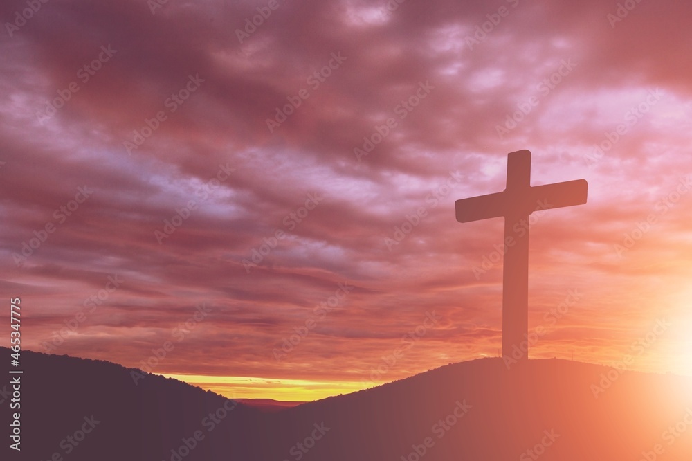 Wooden cross during sunset hour background
