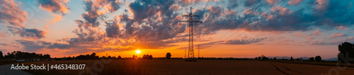 High resolution stitched panorama of a beautiful sunset with a dramatic sky and overland high voltage lines near Tabertshausen, Bavaria, Germany © Martin Erdniss