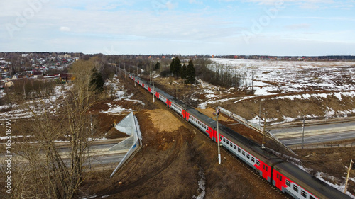 Sergiev Posad, Russia - 03 April 2021: Russian cities, electric train Moscow - Sergiev Posad passes through the bridge photo